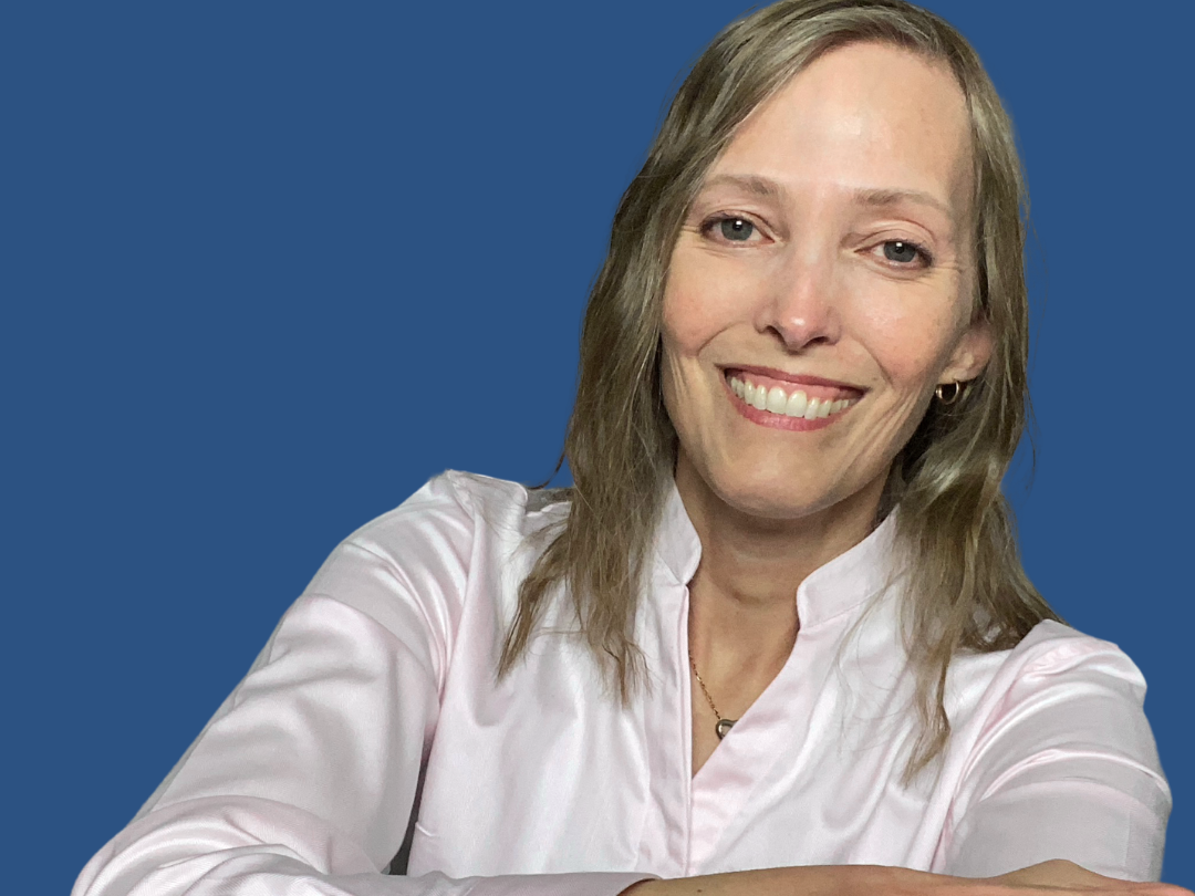 Headshot of Rebecca Silva-Faville, smiling, wearing a white blouse, against a navy blue background